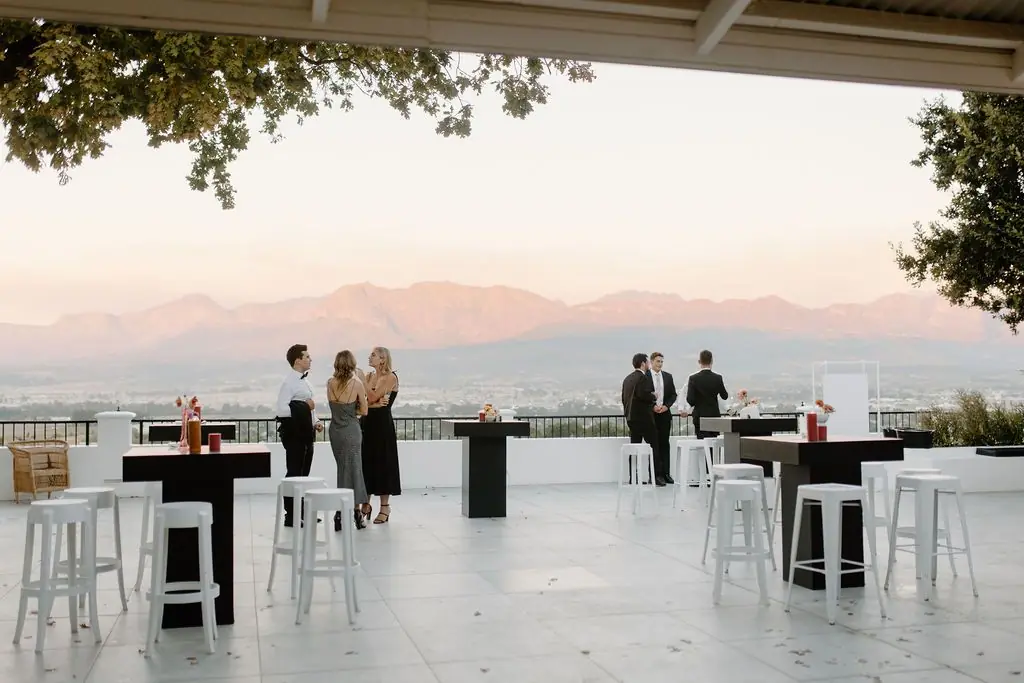 The patio at dusk, the mountains pink across the valley